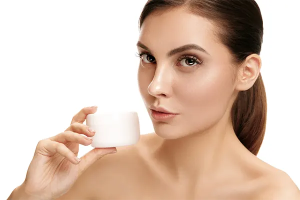 woman applying moisturizer eye cream