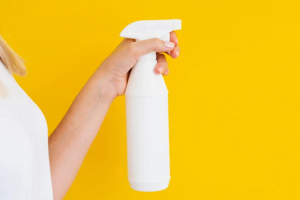 holding a white trigger spray bottle holding a white trigger spray bottle