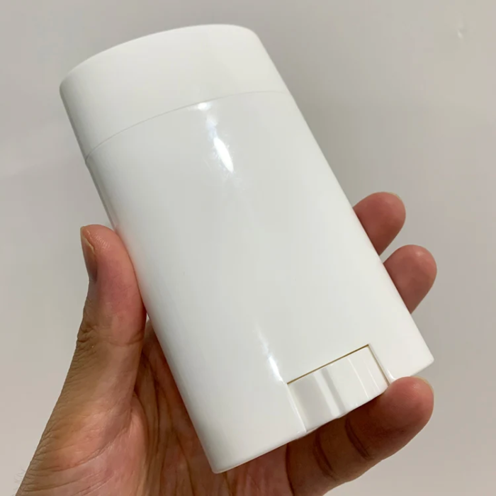 holding an empty deodorant roller bottle 75g