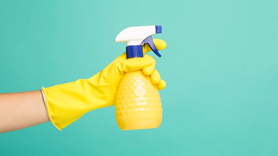 A Food Worker is Putting Chemicals into Clean Spray Bottles