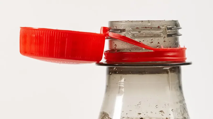 tethered caps on plastic beverage bottle - 1